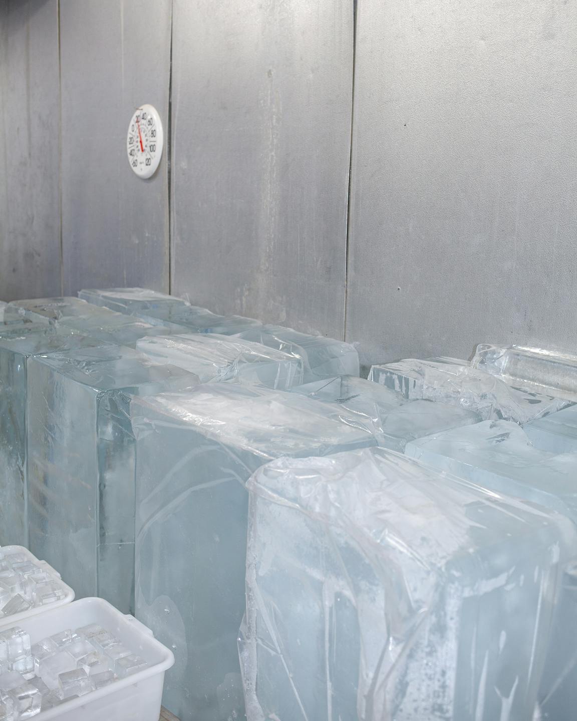 Many blocks of ice in an industrial freezer.
